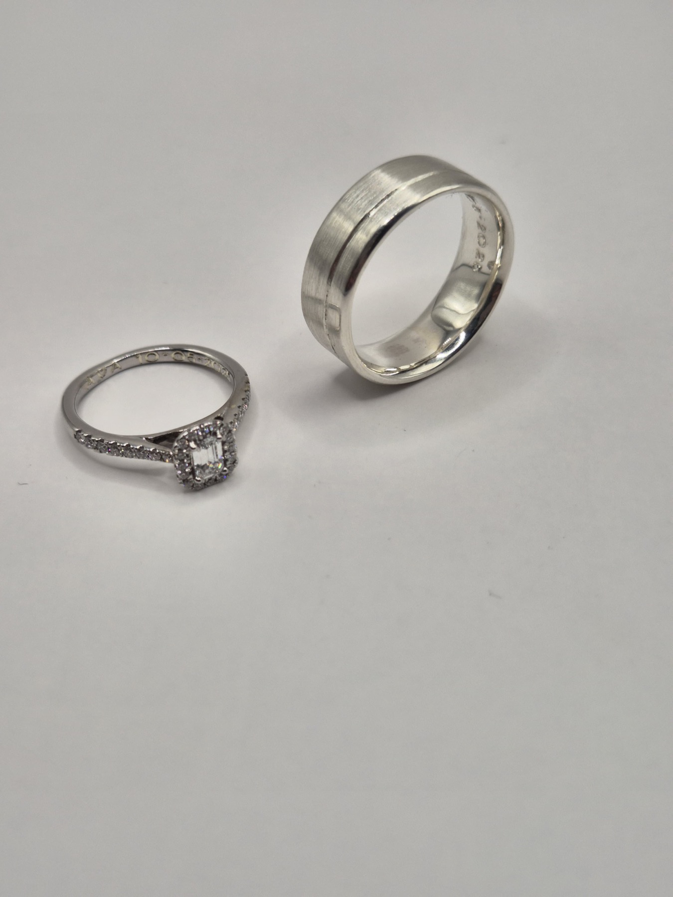 Engagement ring paired with a men's brushed wedding band